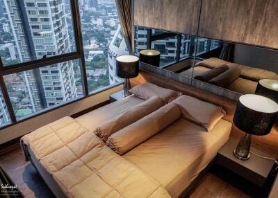 Modern bedroom with panoramic city view and large windows