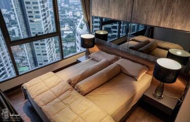 Modern bedroom with panoramic city view and large windows