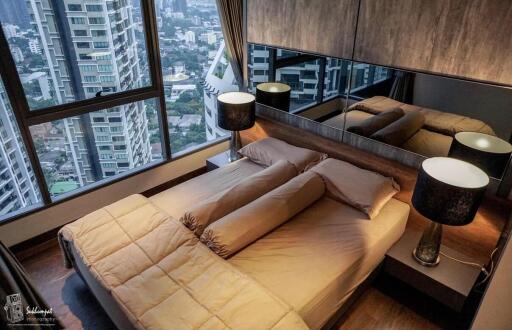 Modern bedroom with panoramic city view and large windows