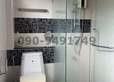 Modern bathroom with glass shower and tiled walls