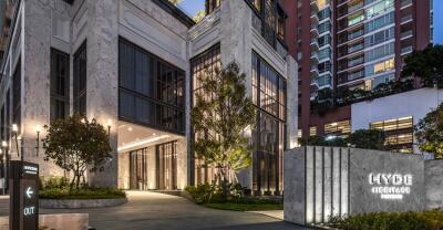 Modern building entrance at dusk with illuminated facade