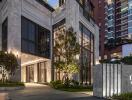 Modern building entrance at dusk with illuminated facade