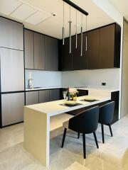 Modern kitchen with a sleek design, equipped with built-in cabinets and a central island