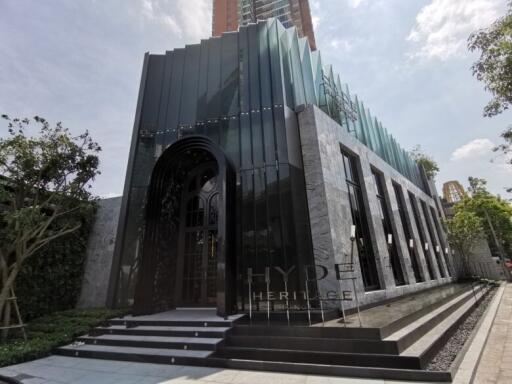 Modern building facade with large arched entrance and glass panels