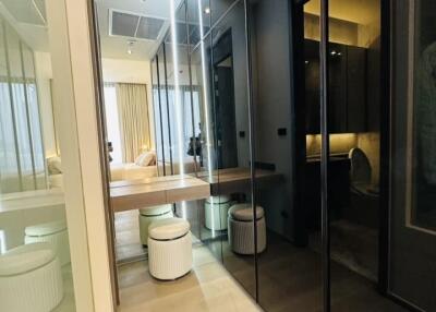 Modern bedroom with en-suite bathroom and reflective glass wardrobe