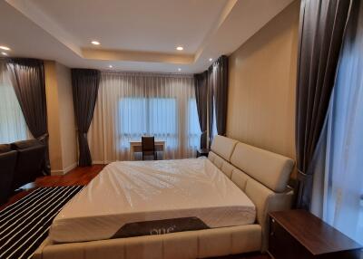 Spacious master bedroom with large bed and modern furnishings