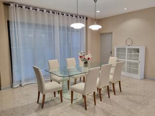 Elegant dining room with glass table and chairs