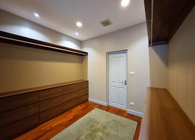 Cozy bedroom with wooden floor and modern lighting