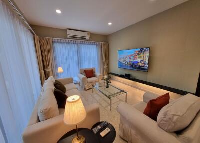 Spacious living room with modern furniture and large television