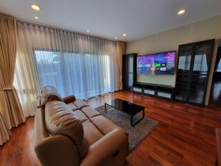 Spacious living room with modern furniture and large windows