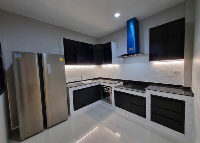 Modern kitchen with stainless steel appliances and black cabinetry