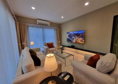 Spacious living room with modern furnishings and ample lighting
