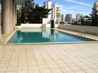 Spacious pool area with a view of the city skyline