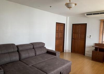 Spacious living room with grey sofa and hardwood flooring