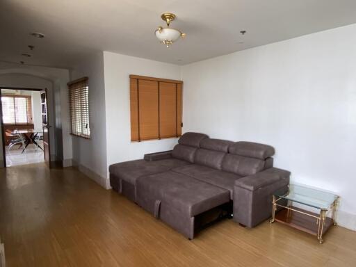 Spacious living room with hardwood floors and ample natural light