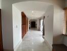 Spacious hallway leading to the main living areas with natural light