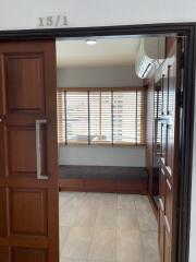 Partial view of an interior room seen from the doorway, with natural light coming through the blinds