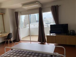 Spacious bedroom with a view of the city skyline