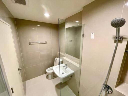 Modern bathroom with walk-in shower and beige tiles