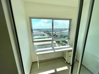 Bright bedroom with large window and city view