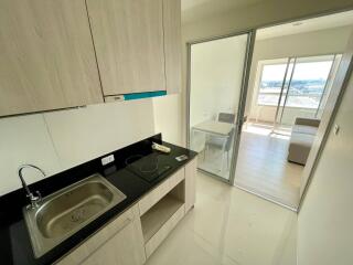 Modern kitchen with ample sunlight and balcony access