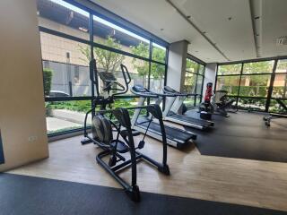 Modern gym with cardio equipment in a residential building