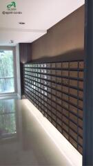 Modern mailroom in residential building with secured mailboxes and natural light