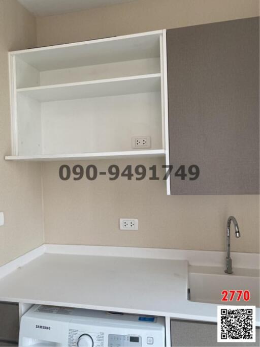 Modern kitchen with white cabinets and stainless steel sink