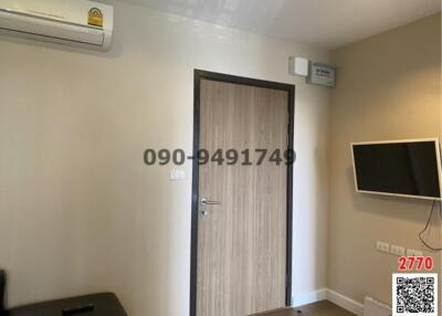 Compact bedroom with air conditioning and wall-mounted TV