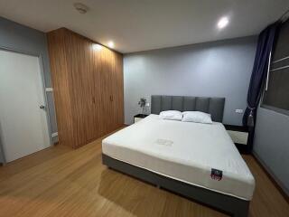 Modern Bedroom with King-sized Bed and Wooden Wardrobe