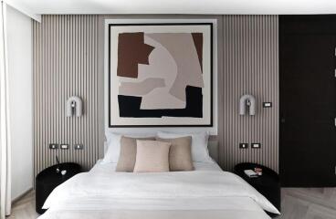 Modern bedroom with a large abstract painting over the bed