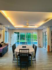 Spacious dining room with modern lighting and direct access to the garden