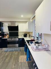 Modern kitchen with stainless steel appliances and white cabinetry