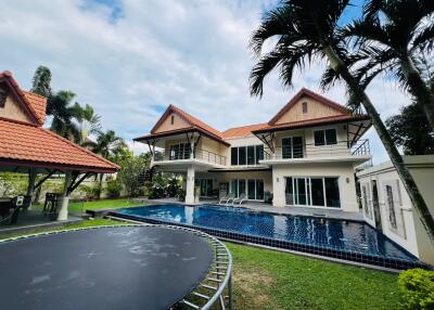 Luxurious house exterior with swimming pool and trampoline