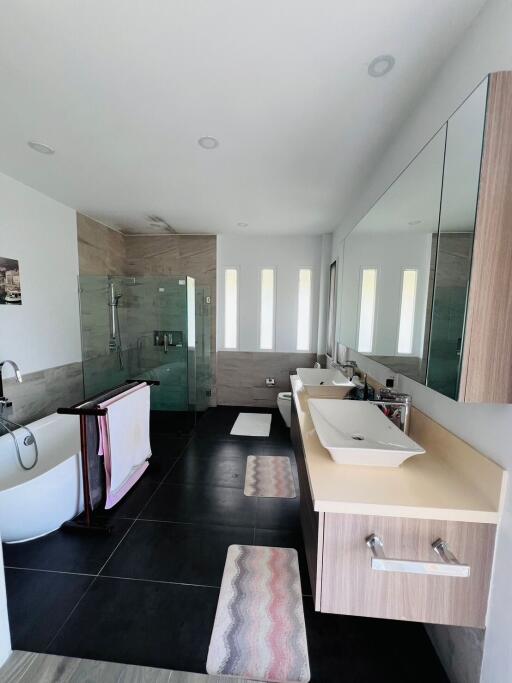 Modern bathroom with dual vanity and glass-enclosed shower