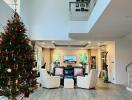 Spacious living room with high ceiling and Christmas tree decoration