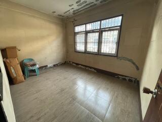 Empty bedroom with tiled flooring and natural light