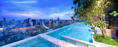 Rooftop swimming pool with city skyline view at dusk