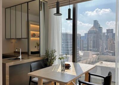 Modern dining area with city view and open-plan kitchen