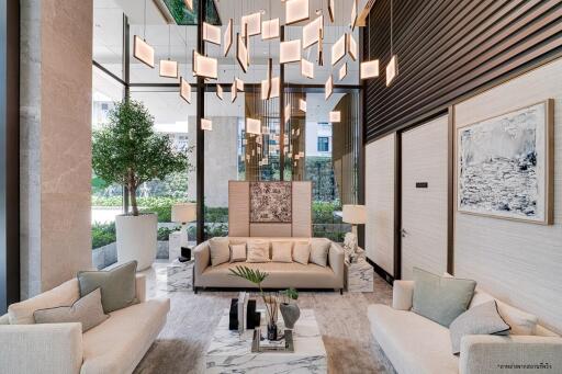 Elegant hotel lobby with modern lighting, comfortable seating, and artistic decor