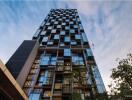 Modern high-rise residential building against a twilight sky