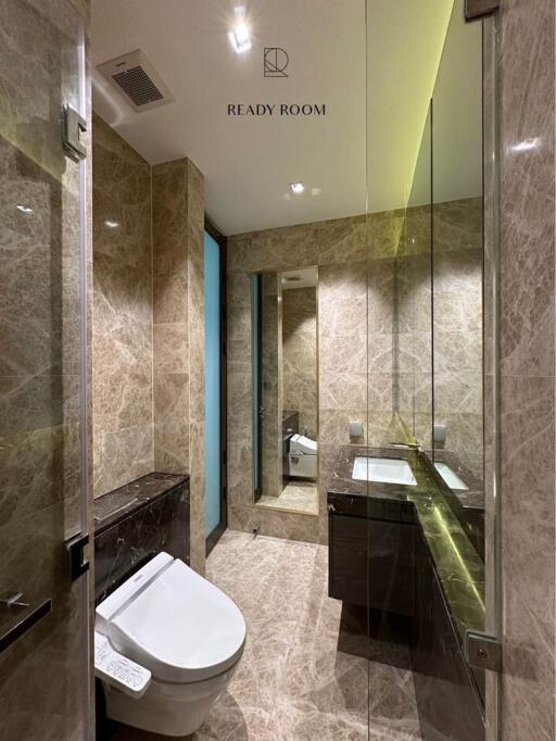 Modern bathroom with natural toned tiles and sleek fixtures