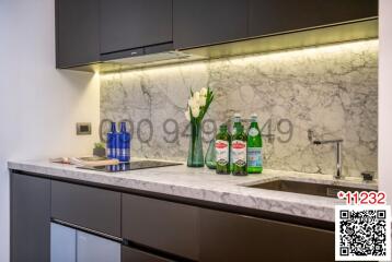 Modern kitchen with marble backsplash and stainless steel appliances