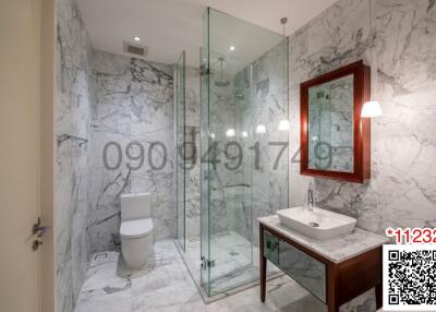 Modern bathroom with marble tiles and glass shower