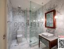 Modern bathroom with marble tiles and glass shower