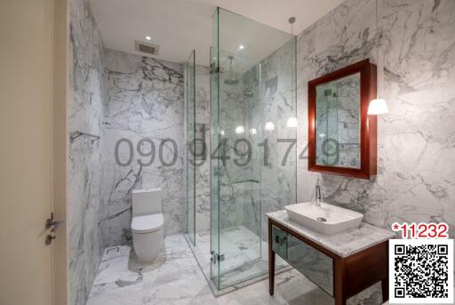 Modern bathroom with marble tiles and glass shower