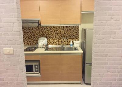 Modern kitchen with wooden cabinets and mosaic backsplash