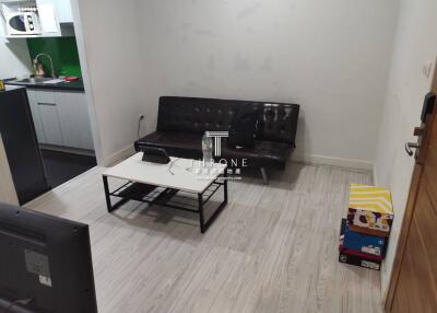 Compact living room with a black sofa and a small coffee table