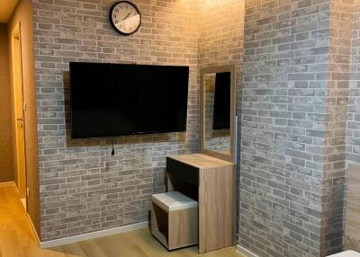 Cozy living room with brick accent wall and mounted television