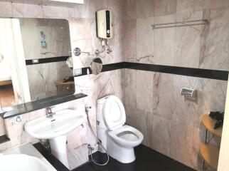 Modern bathroom with marble tiles and essential fixtures